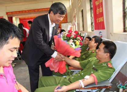 Anh hùng lao động, GS.TS Nguyễn Anh Trí tặng hoa chúc mừng và cảm ơn người hiến máu tại Lễ hội Xuân hồng 2013